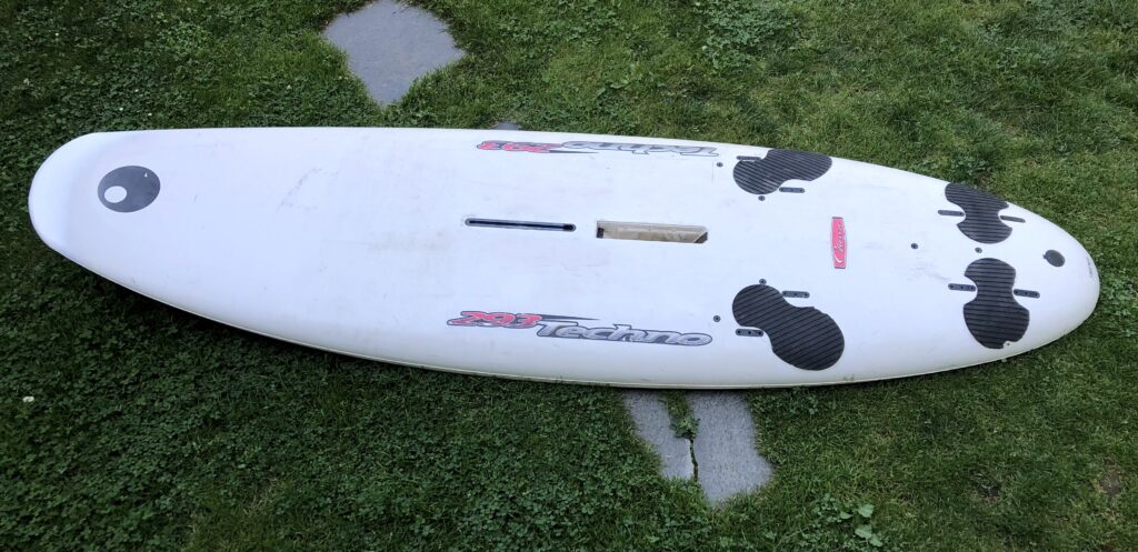 Finished surfboard with repaired nose.